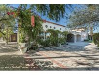 Spanish-style home with a brick driveway and mature landscaping at 4722 N 76Th Pl, Scottsdale, AZ 85251