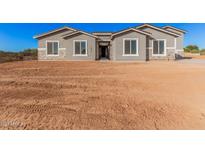Newly constructed home with gray exterior and stone accents at 16970 W Baker St, Surprise, AZ 85387