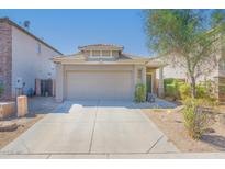 House exterior featuring a two-car garage and a well-maintained front yard at 6034 N Florence Ave, Litchfield Park, AZ 85340