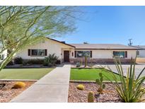 Ranch-style home with landscaped lawn and walkway at 127 E Garfield St, Tempe, AZ 85288