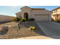 Tan house with arched entryway and two-car garage at 19104 N Smith Dr, Maricopa, AZ 85139