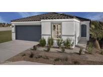 Modern stucco home with dark gray garage door and a landscaped front yard at 3717 S 83Rd Dr, Tolleson, AZ 85353