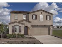 Two-story house with tan exterior, brown shutters, and a two-car garage at 3721 S 83Rd Dr, Tolleson, AZ 85353