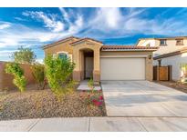 Single story home with two car garage and desert landscaping at 13618 W Shifting Sands Dr, Peoria, AZ 85383