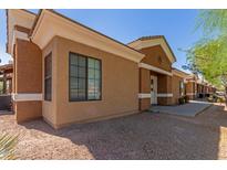 Exterior view of a light brown stucco building with white trim and a walkway at 854 S San Marcos Dr Bldg 1 Dr # A, Apache Junction, AZ 85120