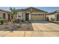 Charming house with a two-car garage and well-manicured front yard at 3103 E Hayfield Way, San Tan Valley, AZ 85140