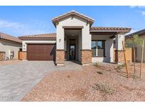 One-story home with brown garage door, stone accents, and landscaped yard at 682 E Aurora Dr, San Tan Valley, AZ 85140