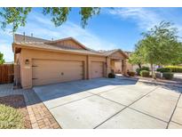 Two-car garage and front entry of tan house at 21527 N 78Th Ln, Peoria, AZ 85382