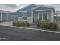 Exterior view of a manufactured home with gray and beige siding at 650 N Hawes Rd # 4409, Mesa, AZ 85207