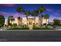 Modern house exterior with palm trees and an elegant entryway at 24351 N 97Th Dr, Peoria, AZ 85383