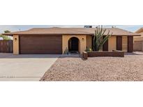 House exterior featuring a two-car garage and desert landscaping at 3837 W Dailey St, Phoenix, AZ 85053