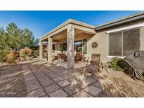 Spacious covered patio with seating area, perfect for outdoor entertaining at 20260 N 272Nd Ln, Buckeye, AZ 85396