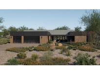 Modern home exterior with three-car garage and desert landscaping at 10610 E Stoney Cir, Scottsdale, AZ 85262