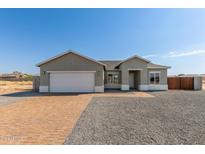 New construction home with a two-car garage and brick driveway at 13563 S Huntington Rd, Arizona City, AZ 85123