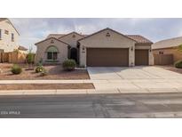 Single-story home with two-car garage and desert landscaping at 27571 N 171St Dr, Surprise, AZ 85387