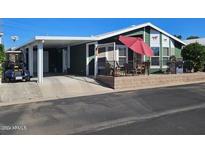 Single-wide manufactured home with carport and covered patio at 650 N Hawes Rd # 4530, Mesa, AZ 85207