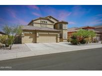 Two-story house with three-car garage and desert landscaping at 18516 W Sweet Acacia Dr, Goodyear, AZ 85338