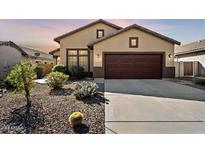 One-story house with desert landscaping and a two-car garage at 653 W Vineyard Plains Dr, San Tan Valley, AZ 85143