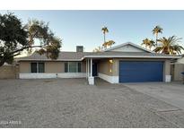 Tan house with a blue garage door and gravel driveway at 2429 E Alameda Dr, Tempe, AZ 85282