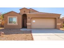 Tan one-story home with a two-car garage at 727 W Judi Dr, Casa Grande, AZ 85122