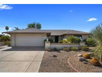 Single-story home with a two-car garage and nicely landscaped yard at 9856 W Rimrock Dr, Peoria, AZ 85382