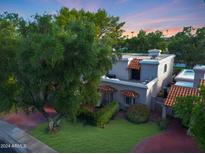 Two-story home with tile roof and mature trees in the front yard at 7285 E Arlington Rd, Scottsdale, AZ 85250