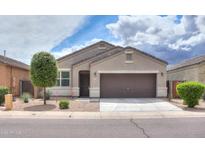 Charming one-story home with a brown garage door and well-manicured front yard at 17078 N Rosemont St, Maricopa, AZ 85138