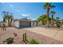 Newly renovated home with a clean design, desert landscaping, and a long driveway at 4839 E Crocus Dr, Scottsdale, AZ 85254