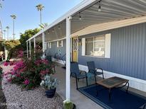 Mobile home exterior with covered porch and landscaping at 4065 E University Dr # 300, Mesa, AZ 85205