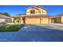 Two-story house with three car garage and solar panels at 12409 N 60Th Ln, Glendale, AZ 85304