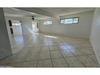 Spacious living room with tile floors and ceiling fan at 3023 W Larkspur Dr, Phoenix, AZ 85029