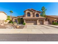Two-story house with three-car garage and desert landscaping at 1367 E Desert Flower Ln, Phoenix, AZ 85048