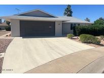 Single story home with attached garage and landscaping at 14406 N Cameo Way, Sun City, AZ 85351