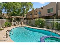 Community pool and spa with a relaxing patio area at 1446 E Grovers Ave # 26, Phoenix, AZ 85022