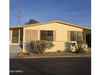 Charming single-story home with desert landscaping and covered entryway at 11596 W Sierra Dawn Blvd # 28, Surprise, AZ 85378