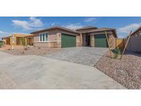 New construction home with two-car garage and attractive landscaping at 25227 N 131St Dr, Peoria, AZ 85383