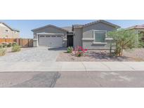 Single-story home with gray exterior and paver driveway at 22207 N Daniel Dr, Maricopa, AZ 85138