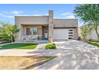 Modern house exterior with a two-car garage and landscaped front yard at 5725 S 101St St, Mesa, AZ 85212