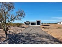 Modern desert home with a large garage and driveway at 31214 N 167Th Ave, Surprise, AZ 85387