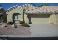 Tan colored house with a two car garage and desert landscaping at 5830 E Mckellips Rd # 62, Mesa, AZ 85215