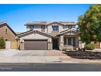 Two-story house with solar panels, brown garage door, and stone accents at 1264 E Walnut Rd, Gilbert, AZ 85298