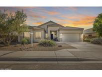 One-story house with tan exterior, two-car garage, and desert landscaping at 8723 E Hillview St, Mesa, AZ 85207