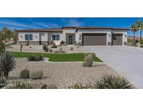 Single story home with a two car garage and desert landscaping at 18066 W Amber Dr, Goodyear, AZ 85338