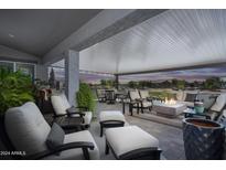 Relaxing covered patio with comfortable seating and fire pit at 331 W Dundy St, San Tan Valley, AZ 85143