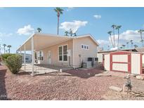 Rear view showing covered patio, shed, and landscaping at 7300 N 51St Ave # D212, Glendale, AZ 85301