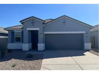 One-story home with gray exterior and two-car garage at 38125 W Excussare Way, Maricopa, AZ 85138