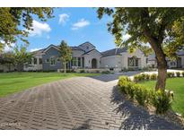 Luxury home with a grand entrance and manicured landscaping at 20445 E Sunset Ct, Queen Creek, AZ 85142