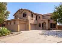 Two story house with a large driveway at 43499 W Courtney Dr, Maricopa, AZ 85138