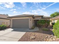 One-story home with gray garage door at 20712 N 273Rd Ave, Buckeye, AZ 85396