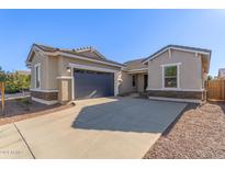 One story home with a two car garage and neutral color scheme at 21033 E Camina Buena Vis, Queen Creek, AZ 85142